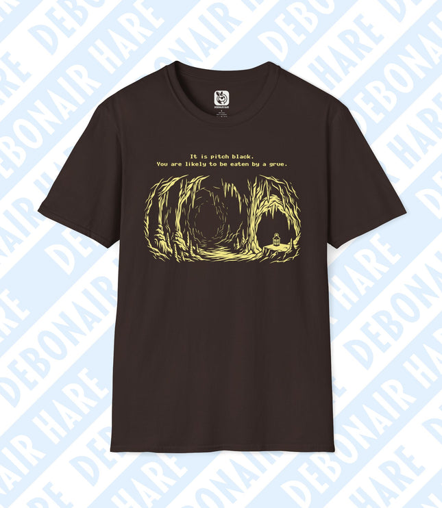 A brown t-shirt with an image of a lonely cave and the text "It is pitch black. You are likely to be eaten by a grue."