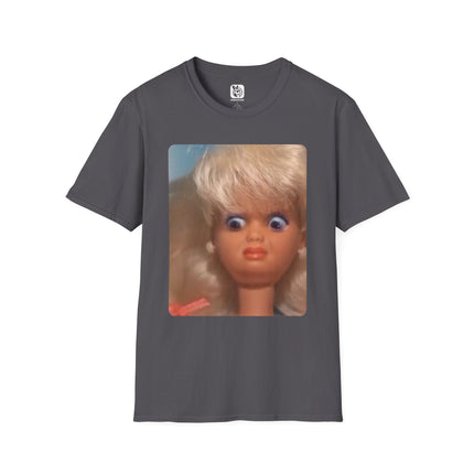 Gray t-shirt with a graphic of a doll's face with a disgusted expression