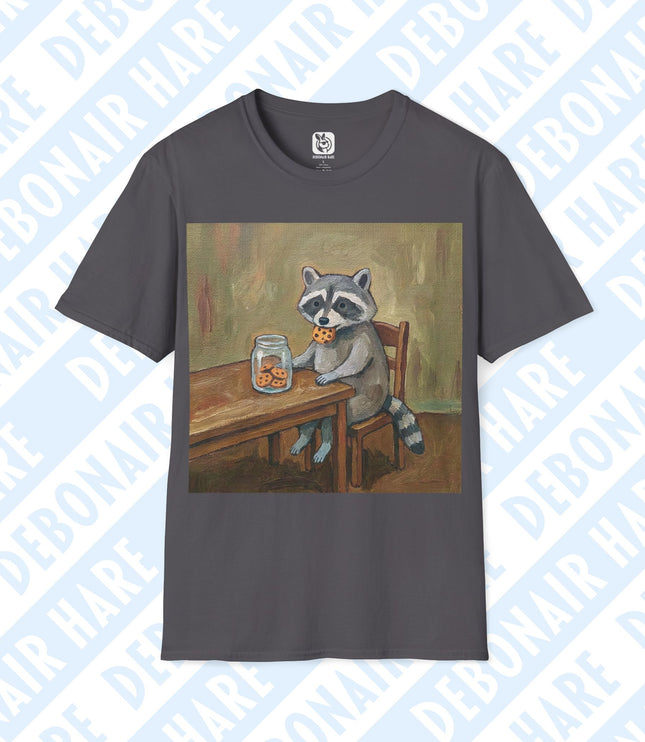 Gray t-shirt depicting a raccoon sitting at a table eating a cookie