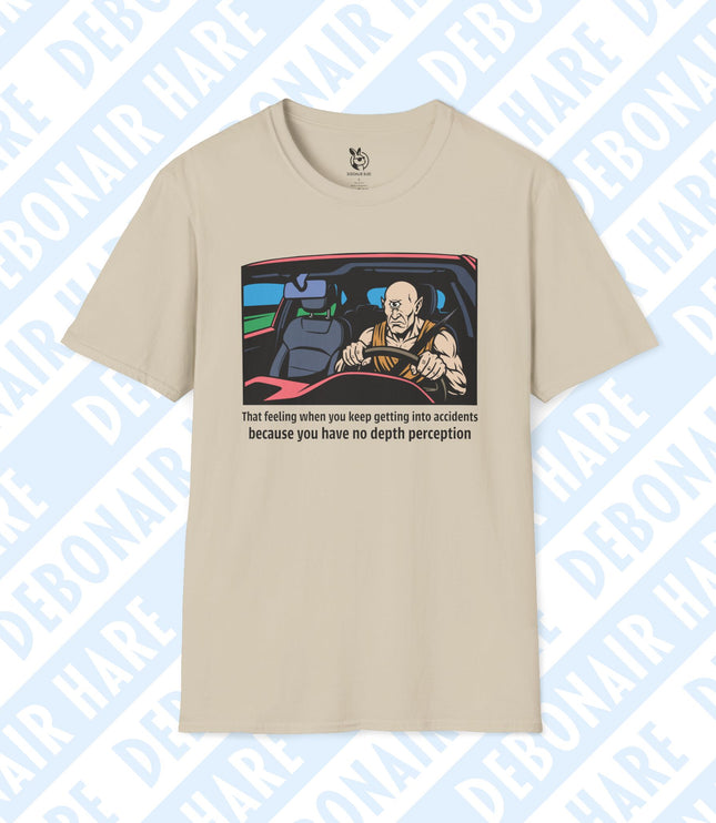 A light beige t-shirt depicting a driving cyclops upset with his lack of depth perception